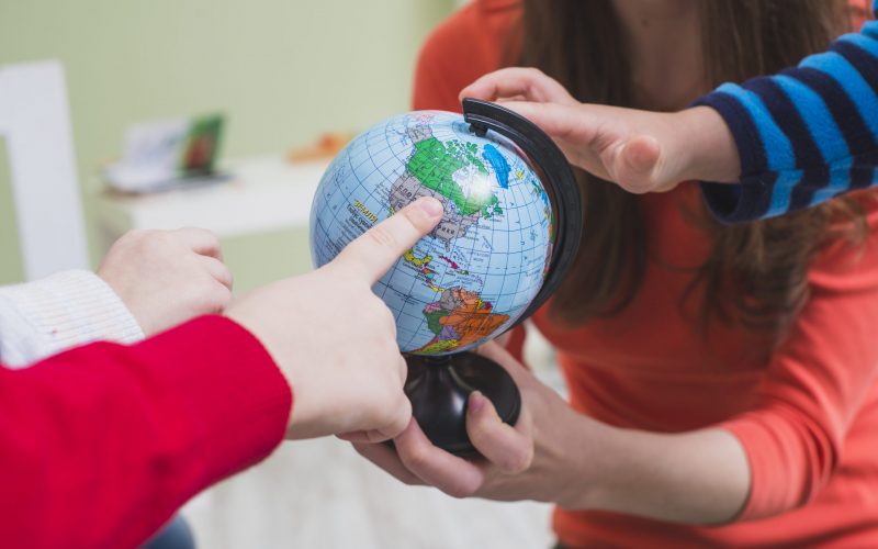 children-touching-globe