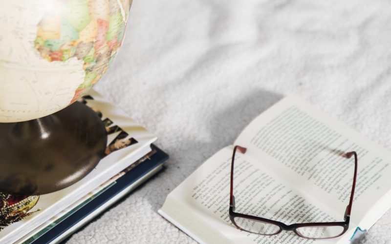 glasses-globe-near-books
